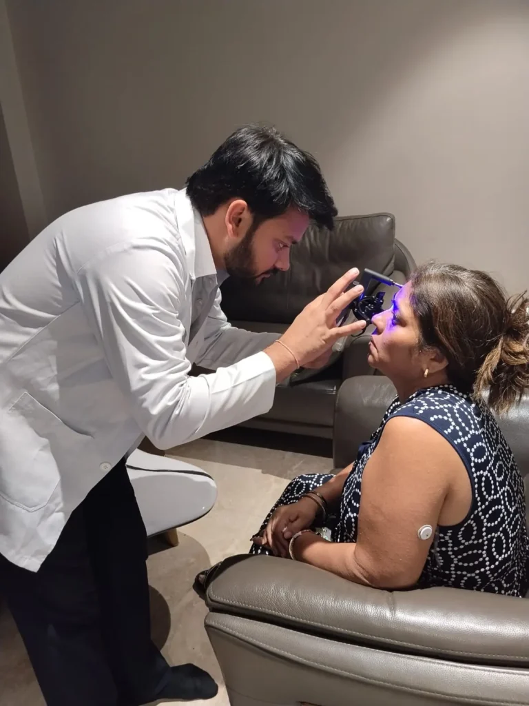 EyeSetu doctor examining a patient's eye with a handheld light at home