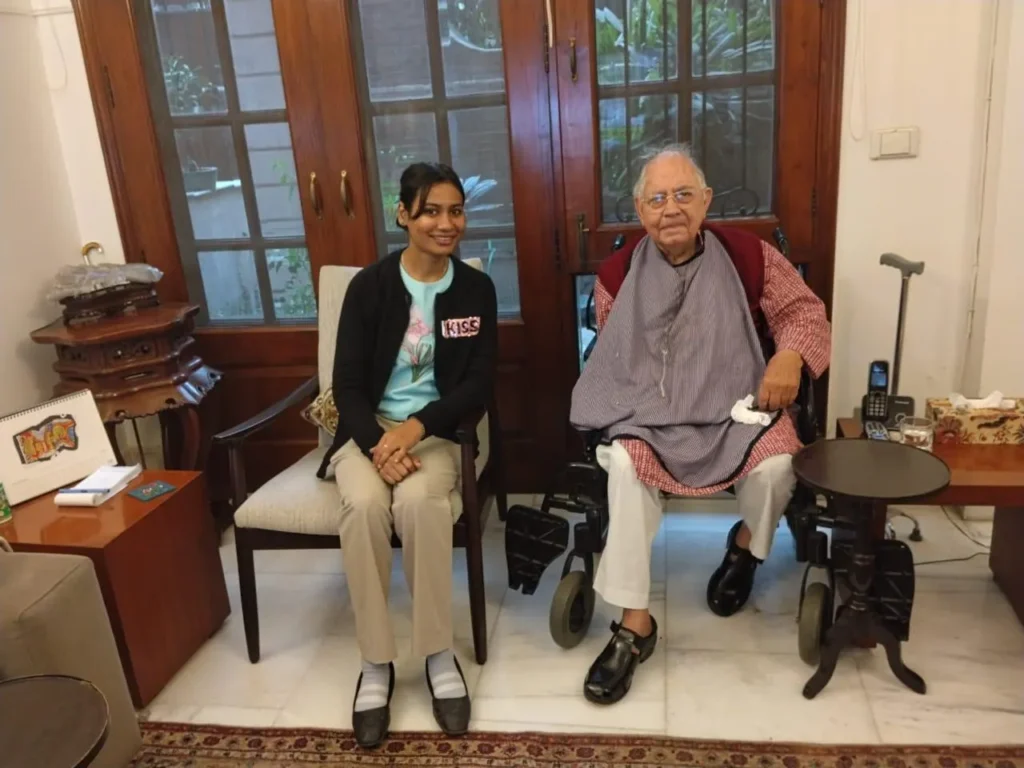 EyeSetu optometrist seated beside an elderly patient in his living room