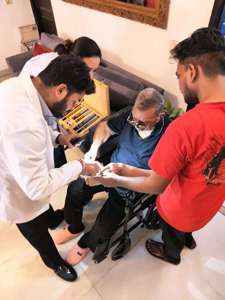 Optometrist and family helping an elderly man in a wheelchair during an eye test