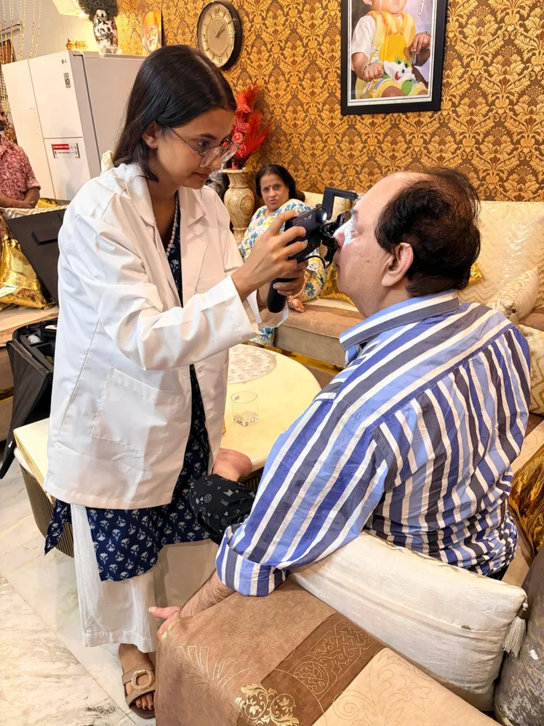 Optometrist examining a man with a handheld eye camera